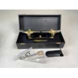 A large cased brass and steel watchmakers depthing tool by JMW Clocks Sheffield. 28cm long. In