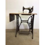 Singer sewing machine with metal base. W:79cm x D:40cm x H:73cm