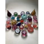 A collection of glass paperweights to include Caithness and other makers.