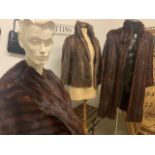 A 1950s musquash fur coat together with a 1950s mink fur jacket and a 1950s mink fur cape.