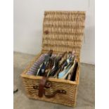 A wicker basket full of EPs to include Slade, Neil Diamond, Monty Python- Always Look on...,