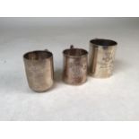 Three Victorian/Edwardian sterling silver miniature mugs. Various dates and makers. Largest 8cm(h)