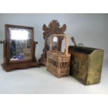 A wall clock, swing mirror, magazine rack and a wicker bottle holder.