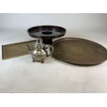 A collection of Oriental style metalware to include an Eastern brass charger, Chinese tray a white