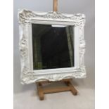 A modern mirror with bevelled edge with white painted moulded frame. W:60cm x H:60cm