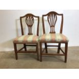 A pair of oak upholstered dining chairs. W:53cm x D:43cm x H:96cm