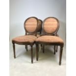 A set of four reproduction upholstered balloon back dining chairs with studwork finish.