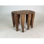A late 19th early 20th century W. African (Yaruba) ten legged tribal round ceremonial table