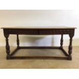 Small oak refectory table with carved freeze and two drawers. W:150cm x D:81cm x H:71cm.