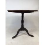 A 19th century oak tripod tilt top table. W:78cm x D:78cm x H:71cm