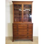 A Georgian secretaitre bookcase with hour glass beading on glazed doors to three adjustable shelves,