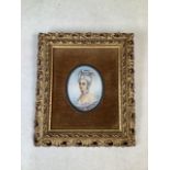 An oval miniature painting of an 18th century lady. Indistinctly signed bottom right in a pierced