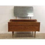 A mid century teak veneered dressing table with mirror and four drawers. Metal handles and feet.