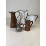 Five metal jugs to include pewter, enamel and copper.