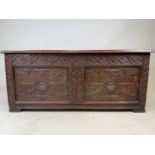 A 19th century carved oak coffer. W:117cm x D:47cm x H:52cm