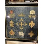 A silk embroidered framed panel of heraldic motifs. W:52cm x H:54cm