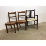 A pair of pitch pine church chairs also with a carver dining chair. W:45cm x D:42cm x H:90cm