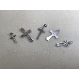 A collection of sterling silver crucifix pendants. (5)