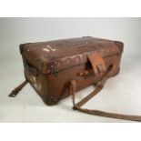 A leather bound travelling trunk. W:78cm x D:48cm x H:32cm