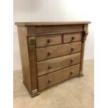 A waxed pine chest of drawers with secret drawer and pillar style supports. W:125cm x D:55cm x H: