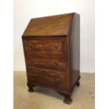 A small 1930s bureau. Drop down front with support stretchers bars three drawers to front. W:61cm