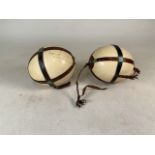 Two ostrich eggs with leather straps. One marked in pen- Nigeria, British West Africa 1928.