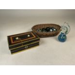 A wicker basket of marbles with a horse shaped paper weight and a early 20th century cash box.