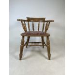 An elm smokers bow arm chair. W:54cm x D:51cm x 75cm