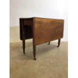 A Victorian mahogany drop leaf table on turned legs with original castors Extended W:122cm x D: