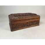 An Indian sandalwood jewellery casket profusely carved with stylised flowers W:32cm x D:21cm x H: