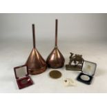 Two copper wine funnels a small ornamental figure and three medals. H:30cm