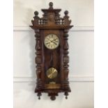 A Vienna regulator wall clock with key and winder with walnut veneer back plate. W:115cm x D: