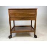 A Mid century sewing table with lift up lid to storage, drawer to side and lower shelf. Large