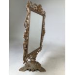 A gilt metal partners dressing table mirror on tripod base, with flip over action. H:49cm