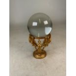 Glass sphere on gilt metal stand. H: 19cm.