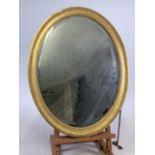 An oval gilt framed bevelled mirror.W:53cm x H:68cm