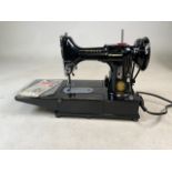 A cased Singer Electric Sewing Machine, Model 222K. To include instruction Manuel, replacement