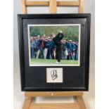 A photograph and autograph of golfer Ernie Els. W:36cm x H:39.5cm