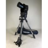 A Mead auto star UHTC telescope on stand with remote control and carry bag.