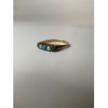 A 9ct gold turquoise and split pearl ring in a scrolling open work setting. 2.0g. Size R