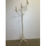 A metal candelabra style standard lamp, cream painted on tri base.