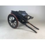 A painted wooden dog cart with rubber wheels. W:75cm x D:42cm x H:40cm