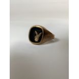 A 9ct gold Playboy signet ring. Oval onyx plaque with yellow metal bunny decoration. 4g