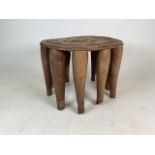 A late 19th early 20th century West African (Yaruba) ten legged tribal round ceremonial table