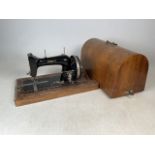 A Singer Harris K sewing machine in wooden carry case with key.