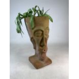 A large terracotta planter in the form of a head. W:29cm x D:29.5cm x H:58.5cm