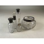 Silver topped scent bottles also with a silver topped jar.