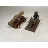 A fire side brass decorative canon with a inkwell of a badger with a wheelbarrow- signed by