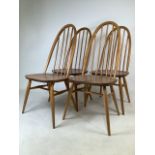 A set of four Ercol blonde elm and beech mid century dining chairs. W:43cm x D:41cm x H:97cm