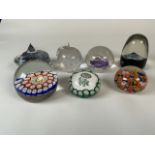 A collection of paperweights to include millefiore examples and one stamped Selkirk glass Scotland